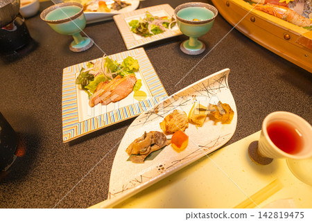 A splendid multi-course meal table laden with small dishes and drinks. A splendid multi-course meal table laden with small dishes and drinks. 142819475