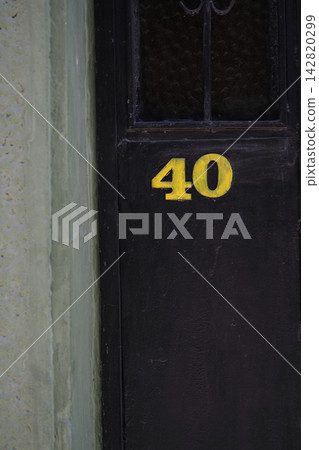 A door marked with the number 40 on a bustling city street A door marked with the number 40 on a bustling city street 142820299