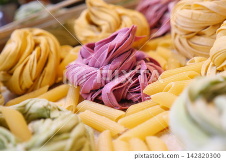 Colorful pasta displayed at a market in the afternoon Colorful pasta displayed at a market in the afternoon 142820300