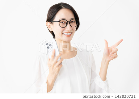 一位戴著眼鏡、身穿T恤的女士正在使用智慧型手機——生活方式圖片 一位戴著眼鏡、身穿T恤的女士正在使用智慧型手機——生活方式圖片 142820721