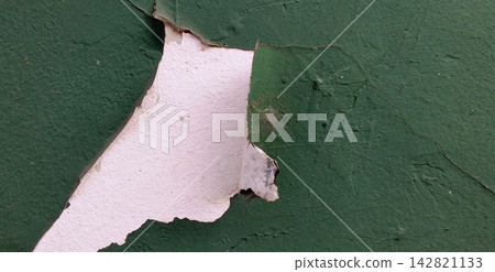 Peeling green paint and exposed white walls. Peeling green paint and exposed white walls. 142821133