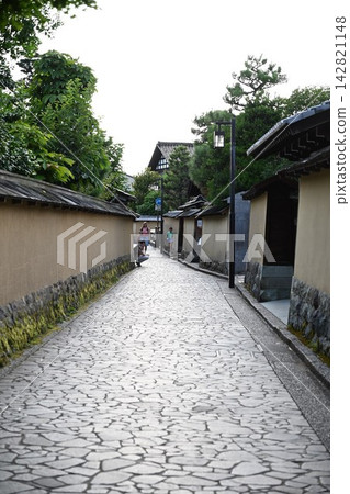 A cobblestone street lined with samurai residences. A cobblestone street lined with samurai residences. 142821148