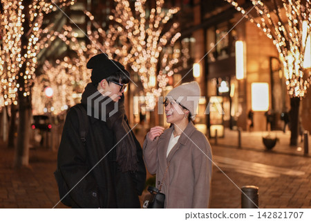 A young couple talking under the illuminations. A young couple talking under the illuminations. 142821707