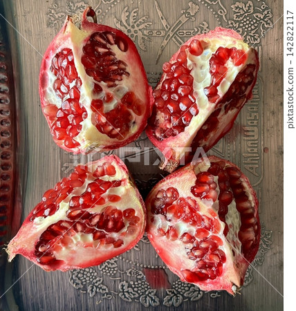 Juicy, red pomegranate seeds bursting with flavor and antioxidants, perfect for snacking or adding a fresh, tangy touch to salads, smoothies, and desserts. Juicy, red pomegranate seeds bursting with flavor and antioxidants, perfect for snacking or adding a fresh, tangy touch to salads, smoothies, and desserts. 142822117