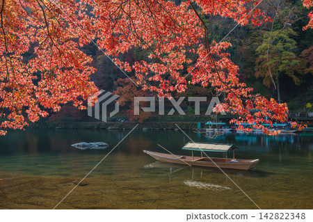 Arashiyama Kyoto Japan, wooden traditional fishing boat at Katsura river in autumn season Arashiyama Kyoto Japan, wooden traditional fishing boat at Katsura river in autumn season 142822348