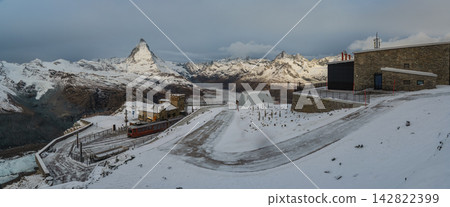Zermatt Switzerland, panorama view of Matterhorn mountain peak and Gornergrat bahn train in winter season Zermatt Switzerland, panorama view of Matterhorn mountain peak and Gornergrat bahn train in winter season 142822399