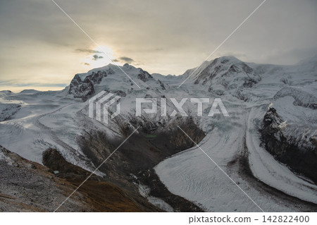 Gornergrat Zermatt Switzerland, sunrise at Monte Rosa peak and Alps mountain range in winter Gornergrat Zermatt Switzerland, sunrise at Monte Rosa peak and Alps mountain range in winter 142822400