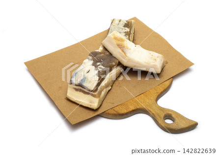 Two pieces of salted bacon on the kitchen board Two pieces of salted bacon on the kitchen board 142822639