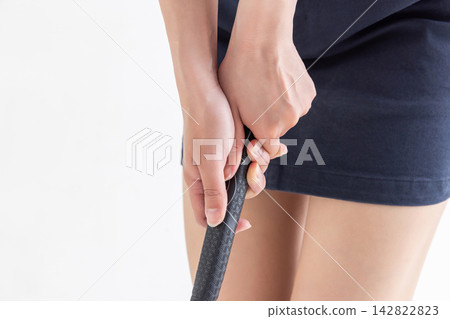 一雙女人的手握著一支高爾夫球桿 一雙女人的手握著一支高爾夫球桿 142822823