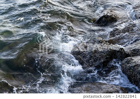 Waves crash over barnacle-covered rocks Waves crash over barnacle-covered rocks 142822841