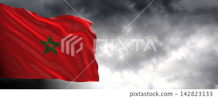 Morocco Flag Waving Against Dark Cloudy Sky Morocco Flag Waving Against Dark Cloudy Sky 142823133