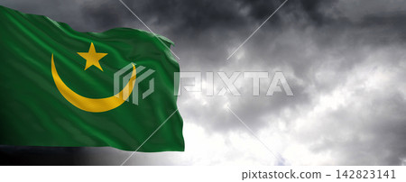 Mauritania Flag Waving Against Dark Cloudy Sky Mauritania Flag Waving Against Dark Cloudy Sky 142823141