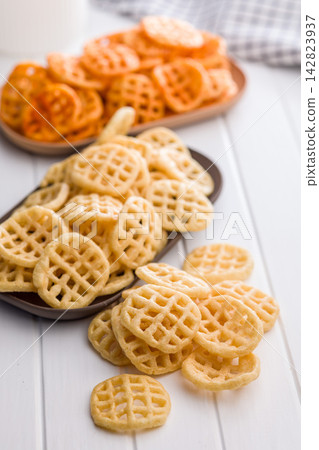 Stack of Waffle Potato Chips and Crisps on White Tabletop Snack Platter Stack of Waffle Potato Chips and Crisps on White Tabletop Snack Platter 142823937