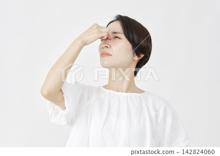 Middle-aged woman, eye strain, white background Middle-aged woman, eye strain, white background 142824060