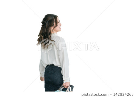 The back view of a businesswoman walking with a suitcase. The back view of a businesswoman walking with a suitcase. 142824263