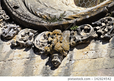 Details of intricate stonework of a window at Convento de Cristo in Tomar, Portugal Details of intricate stonework of a window at Convento de Cristo in Tomar, Portugal 142824542
