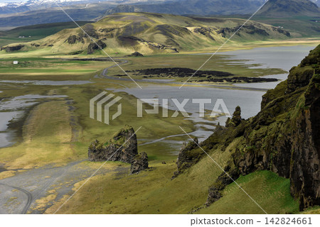 Winding road through a green volcanic valley towards Eyjafjallajokull glacier Iceland Winding road through a green volcanic valley towards Eyjafjallajokull glacier Iceland 142824661