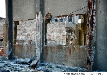 Beyond the remnants of the window frame lies the ruined space of Gunkanjima and the traces of its collapse. Beyond the remnants of the window frame lies the ruined space of Gunkanjima and the traces of its collapse. 142824939
