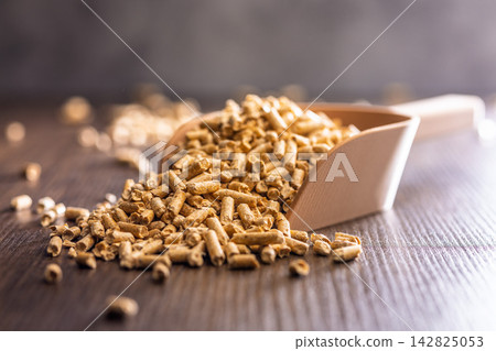 Wood Pellets Fuel Biomass in Scoops on Wooden Table for Heating and Energy Use Wood Pellets Fuel Biomass in Scoops on Wooden Table for Heating and Energy Use 142825053