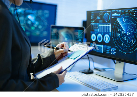 Professional monitoring aviation data on digital radar screens, analyzing flight tracking, aircraft navigation and advanced aerospace technology 142825437