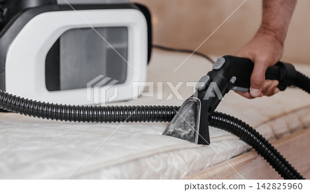 Professional mattress cleaning with extraction vacuum cleaner nozzle and equipment at home Professional mattress cleaning with extraction vacuum cleaner nozzle and equipment at home 142825960