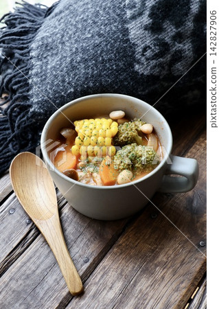 A wool blanket and a vegetable-rich soup with soy milk and tomatoes. A wool blanket and a vegetable-rich soup with soy milk and tomatoes. 142827906