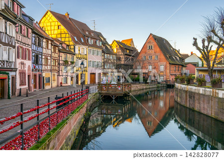 The beautiful scenery of the canals and half-timbered houses of Petite Venice in Colmar, France, bathed in the light of dusk. The beautiful scenery of the canals and half-timbered houses of Petite Venice in Colmar, France, bathed in the light of dusk. 142828077