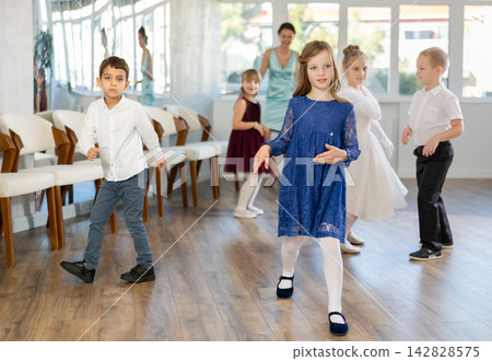 Preteen girl dancing twist with classmates during school party Preteen girl dancing twist with classmates during school party 142828575