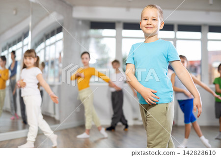 Boy learn to dance modern dances, repeat movement with unrecognizable teacher. Boy learn to dance modern dances, repeat movement with unrecognizable teacher. 142828610