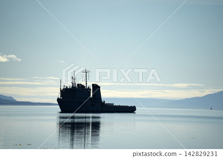 Military Ship Silhouette on Calm Waters of Ushuaia Bay 142829231