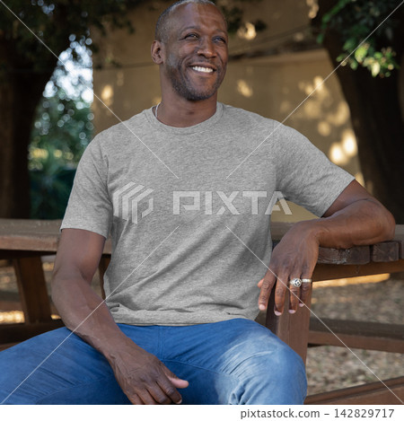 Blank heather grey t-shirt mockup on smiling black man outdoors, front view with copy space Blank heather grey t-shirt mockup on smiling black man outdoors, front view with copy space 142829717