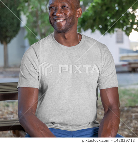 Blank heather grey t-shirt mockup on smiling black man outdoors, front view with copy space Blank heather grey t-shirt mockup on smiling black man outdoors, front view with copy space 142829718