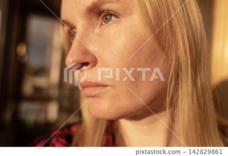 Close up of woman with oily skin, enlarged pores, and redness. She touches her face showing skin texture, acne scars, and pigmentation during a dermatology skincare routine. Close up of woman with oily skin, enlarged pores, and redness. She touches her face showing skin texture, acne scars, and pigmentation during a dermatology skincare routine. 142829861