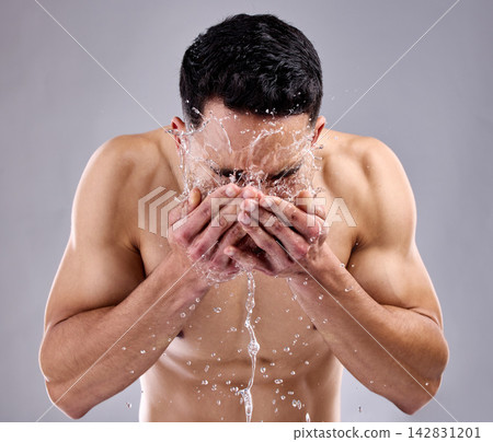 Man, splash and water for cosmetic, wellness and skincare with grooming, routine and body care. Male person, face and gray background for health, fitness and dermatology for hygiene, clean and glow 142831201
