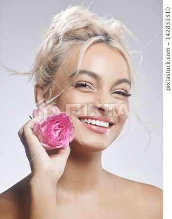 Studio portrait, beauty and woman with rose for sustainable cosmetics, skin glow and natural skincare. Model girl, flower and floral makeup by grey background for spa aesthetic and vegan dermatology Studio portrait, beauty and woman with rose for sustainable cosmetics, skin glow and natural skincare. Model girl, flower and floral makeup by grey background for spa aesthetic and vegan dermatology 142831310