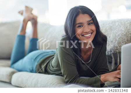 Woman, laptop and portrait with smile on sofa in house for blog or social media with happiness. Technology, streaming and movies on weekend for relax in living room with subscription for video. Woman, laptop and portrait with smile on sofa in house for blog or social media with happiness. Technology, streaming and movies on weekend for relax in living room with subscription for video. 142831348