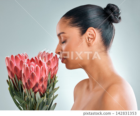 Smell, woman and skincare with plant in studio on white background for organic or natural cosmetics. Female person, treatment and protea flower for skin glow, smooth and wellness for sustainability Smell, woman and skincare with plant in studio on white background for organic or natural cosmetics. Female person, treatment and protea flower for skin glow, smooth and wellness for sustainability 142831353