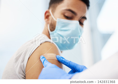 Doctor, man and plaster on arm for injection, healthcare and immunity booster for patient in clinic. Person, bandage and hospital consultation for vaccine, face mask and band aid for influenza shot 142831368