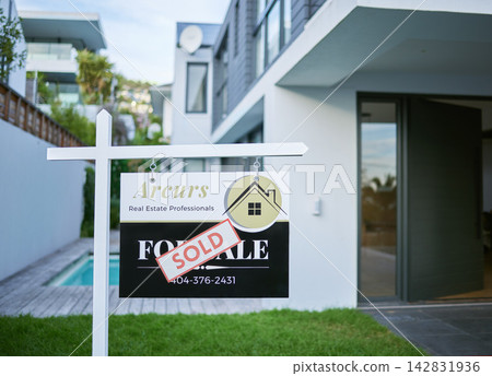 House, sold and sign with billboard for real estate, property or building investment on grass field in yard. Closeup of poster, sale or new home for rent, setup or mortgage of land or architecture House, sold and sign with billboard for real estate, property or building investment on grass field in yard. Closeup of poster, sale or new home for rent, setup or mortgage of land or architecture 142831936