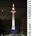 Kyoto Tower lit up against the night sky 142832113