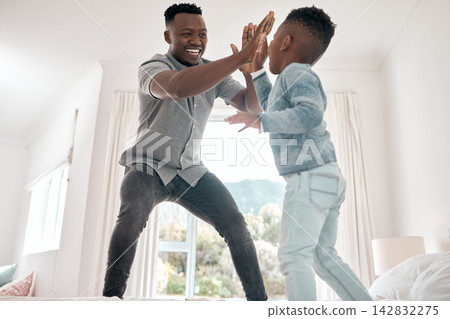 Happy, father and boy with high five on bed for playing, bonding and fun time in morning at home. Excited, family and child with smile and hand gesture for affection, love and growth in bedroom Happy, father and boy with high five on bed for playing, bonding and fun time in morning at home. Excited, family and child with smile and hand gesture for affection, love and growth in bedroom 142832275