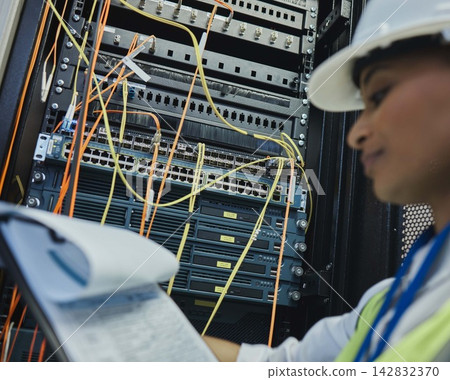 Network engineer, document and server room for internet infrastructure and lights of computer. Woman, IT support and cybersecurity with data center, software and company info for cloud computing Network engineer, document and server room for internet infrastructure and lights of computer. Woman, IT support and cybersecurity with data center, software and company info for cloud computing 142832370