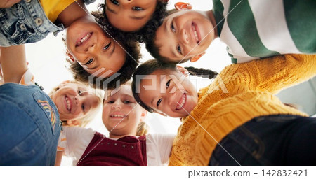 Huddle, support and happy children in school for education, community or development. Low angle, diversity and group of friends with smile in playground for solidarity, teamwork or playing together Huddle, support and happy children in school for education, community or development. Low angle, diversity and group of friends with smile in playground for solidarity, teamwork or playing together 142832421