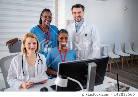 Diverse medical team collaborating in modern office during workday Diverse medical team collaborating in modern office during workday 142832560