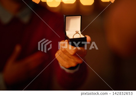 Person, hand and ring box for engagement proposal for marriage question at night, romantic or surprise. Jewellery, diamond and valentines day celebration or announcement ask, elegant or relationship Person, hand and ring box for engagement proposal for marriage question at night, romantic or surprise. Jewellery, diamond and valentines day celebration or announcement ask, elegant or relationship 142832653