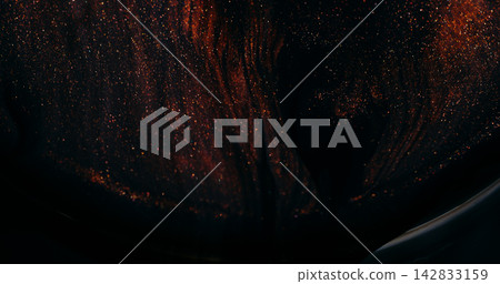 Ink spill. Sparkling fluid. Defocused orange golden color glitter mix acrylic texture floating on abstract art dark background. Ink spill. Sparkling fluid. Defocused orange golden color glitter mix acrylic texture floating on abstract art dark background. 142833159