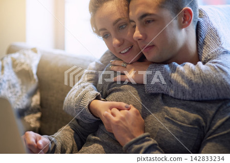 Couple, hug and relax on sofa at house together in living room with affection, bonding and love on weekend. Smile, man and woman in relationship in lounge streaming on laptop for entertainment Couple, hug and relax on sofa at house together in living room with affection, bonding and love on weekend. Smile, man and woman in relationship in lounge streaming on laptop for entertainment 142833234