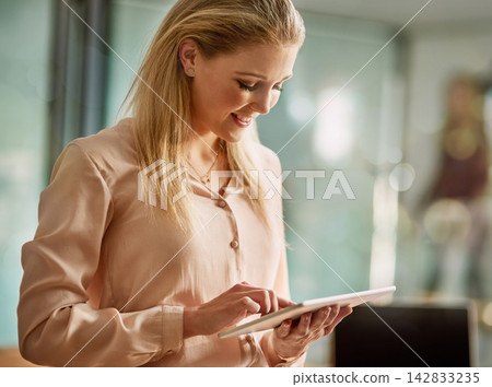 Woman, employee and happy with tablet in office for online communication and networking. Female person, smile and browse internet for social media or news update with entertainment, fun and enjoy Woman, employee and happy with tablet in office for online communication and networking. Female person, smile and browse internet for social media or news update with entertainment, fun and enjoy 142833235