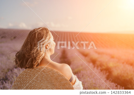 Woman lavender field sitting amidst blooming flowers during a golden sunset with copy space for text Woman lavender field sitting amidst blooming flowers during a golden sunset with copy space for text 142833364