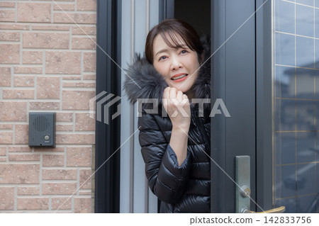 一個面色冷漠的女人打開了前門。 一個面色冷漠的女人打開了前門。 142833756